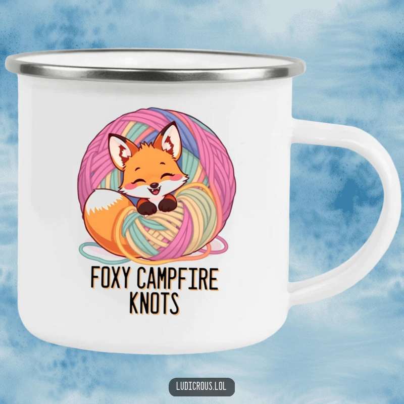 Funny giggling fox tangled in a giant ball of yarn on a camping mug, perfect for humorous and cozy outdoor enjoyment.