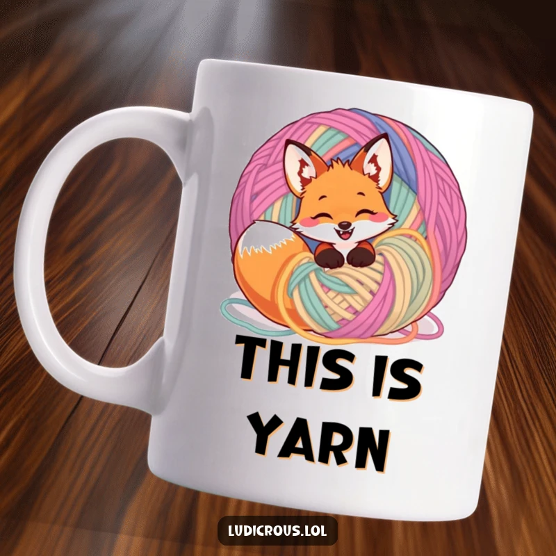 Funny giggling fox tangled in a giant ball of colorful yarn on a mug, expressing playful chaos and joy.