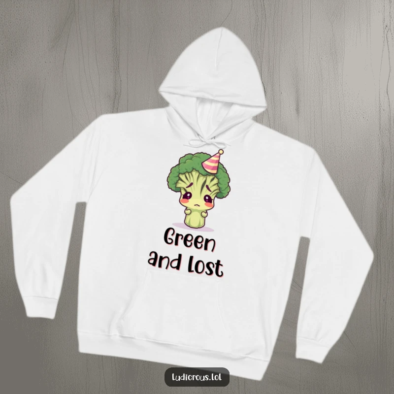 Funny broccoli floret wearing a tiny party hat, looking confused, featured on a soft hoodie for maximum cozy humor.