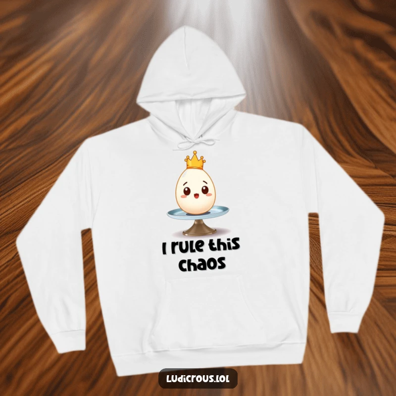 Funny hoodie featuring a surprised egg with a tiny crown wobbling precariously on a spinning plate, ideal for cozy humor.