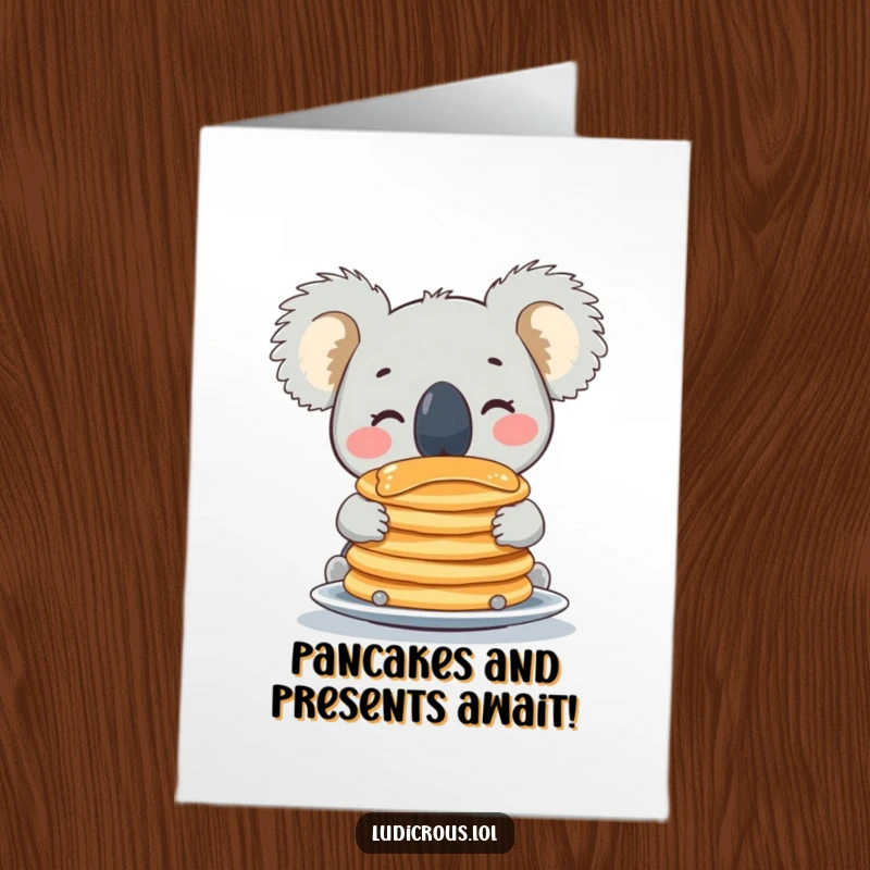 Funny free printable birthday card featuring a beaming koala perfectly balancing a huge stack of pancakes on its nose.