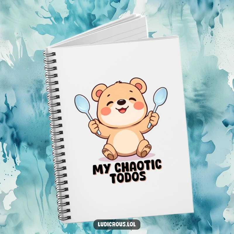 Funny notebook featuring a smiling bear cub juggling bent spoons. Ideal for notes, journaling, and creative brainstorming. Humorous design.