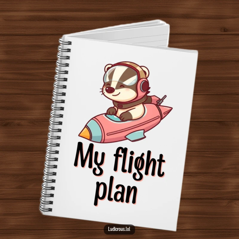 Funny badger in a helmet pilots a comically large rocketship, on the cover of a notebook for writing and planning.