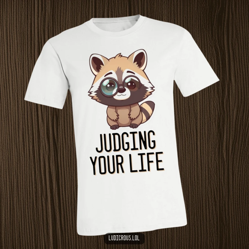 Funny raccoon t-shirt depicting a curious bandit sporting a comically oversized monocle, looking perplexed and demonstrating intellectual humor.