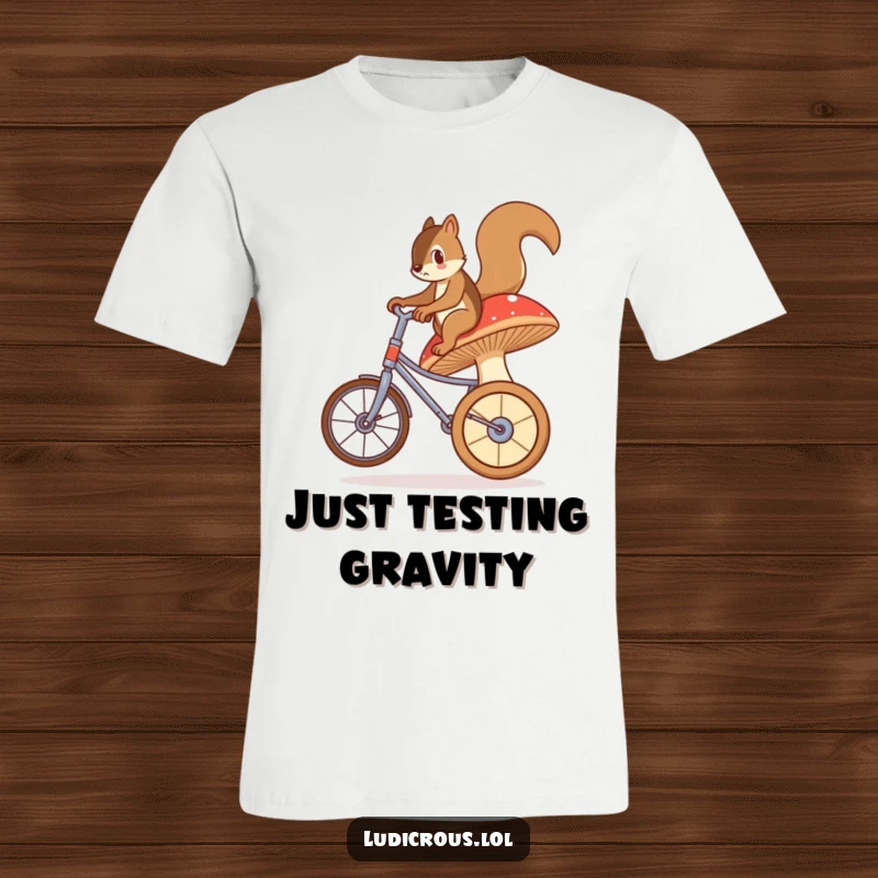 Funny t-shirt depicting a bewildered squirrel attempting to balance and ride a large, unstable mushroom as if it were a unicycle.