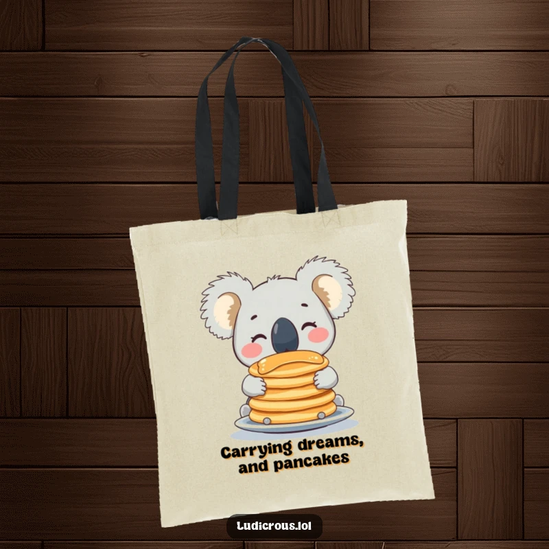 Funny koala tote bag featuring a beaming character balancing a delicious stack of pancakes on its nose, practical and amusing.