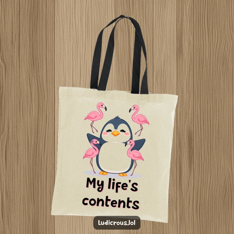 Funny tote bag featuring a silly penguin attempting to juggle three flamingos with a confused look, perfect for humorous carrying.